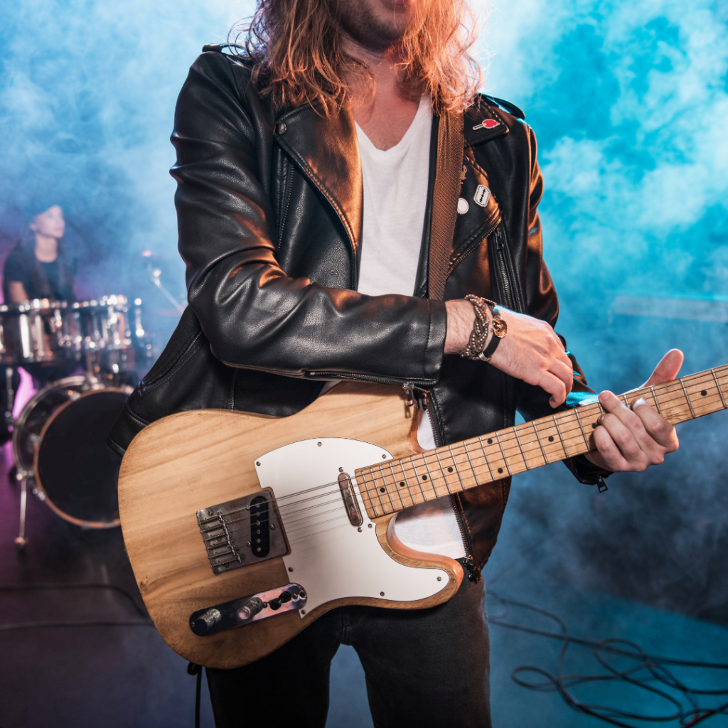 Man holder Fender Guitar, classic rock examples