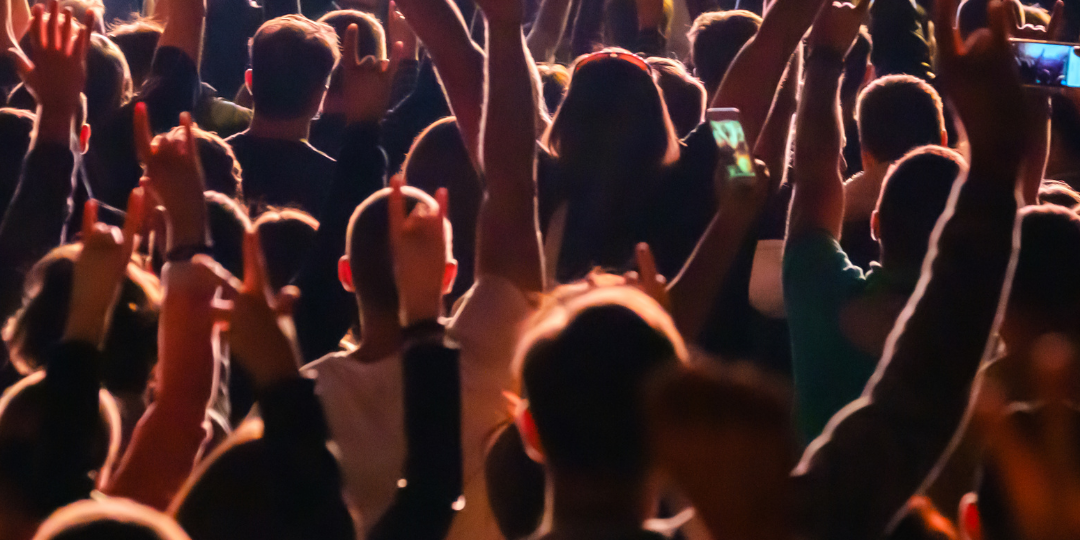 Crowd at rock concert how to tour abroad with your band